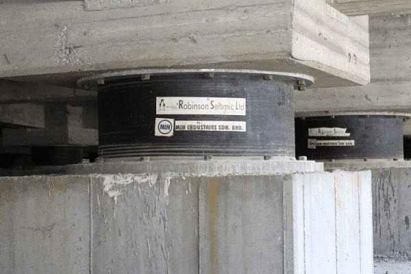 Seismic isolation bearings installed between concrete foundation supports and the structure above